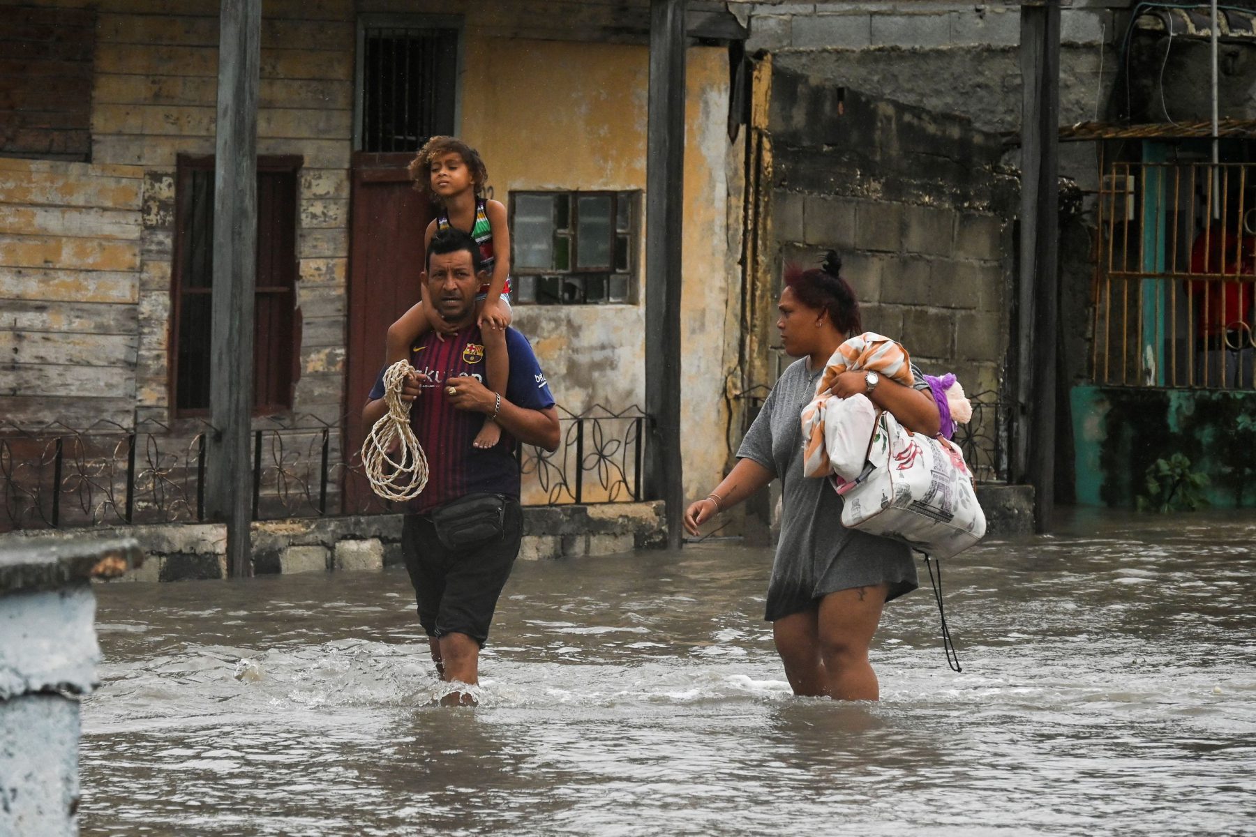 People walk through a flooded street in Batabano, Cuba during the passage of hurricane Ian.