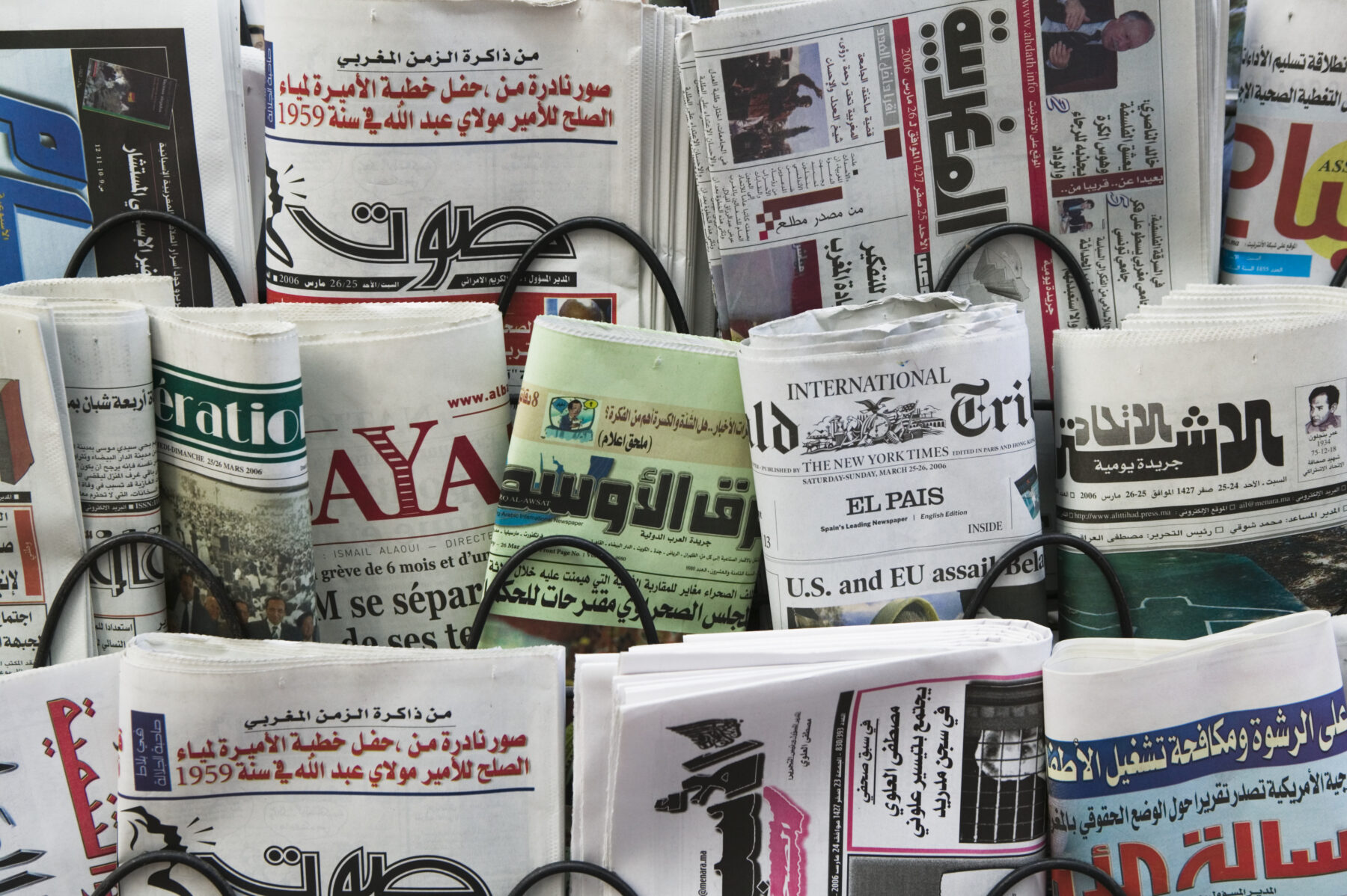 Newspapers for sale in rack, close up
