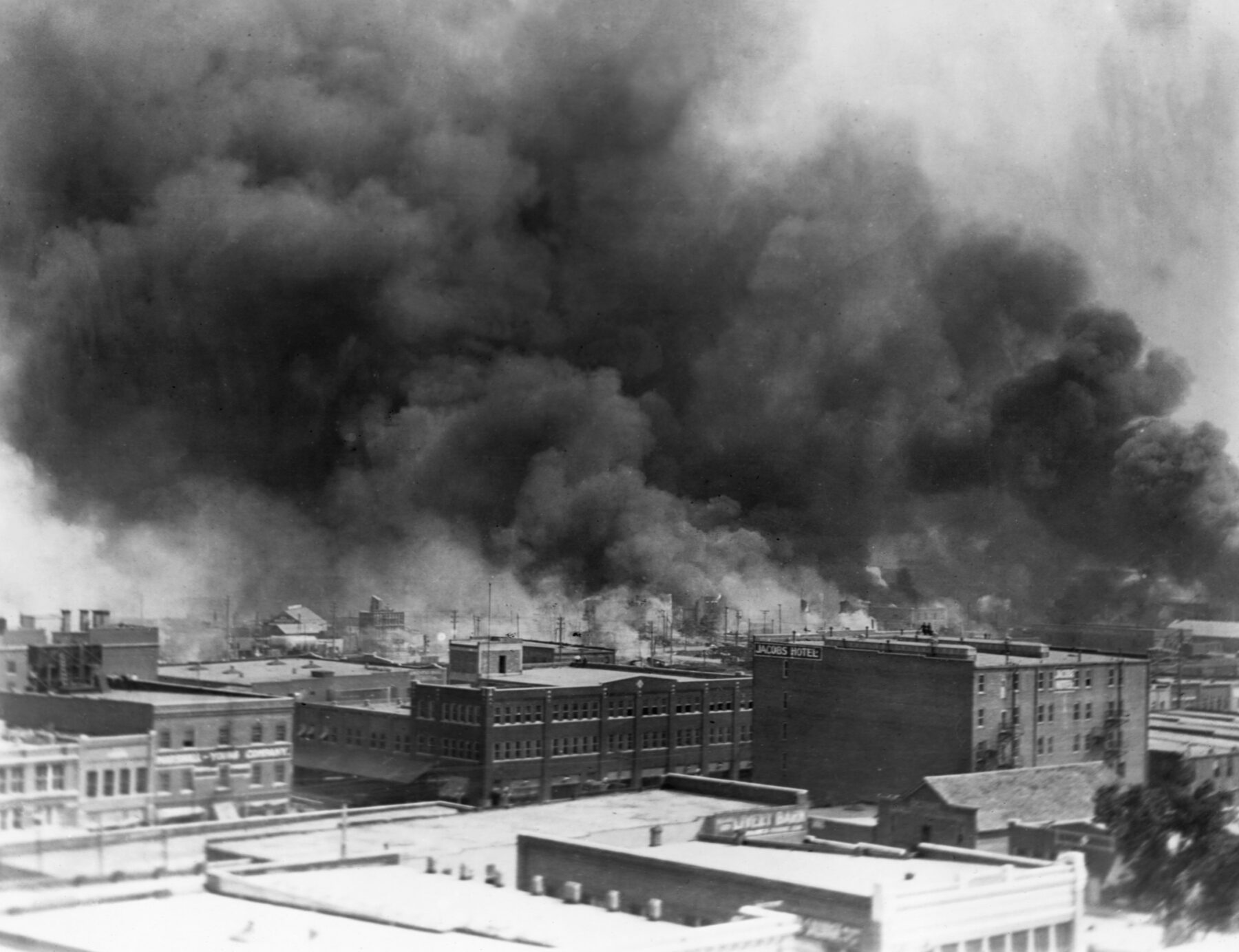 Black smoke billows from fires during the Tulsa Race Massacre of 1921, in the Greenwood District, Tulsa, Oklahoma, US, June 1921. (Photo by © CORBIS/Corbis via Getty Images)