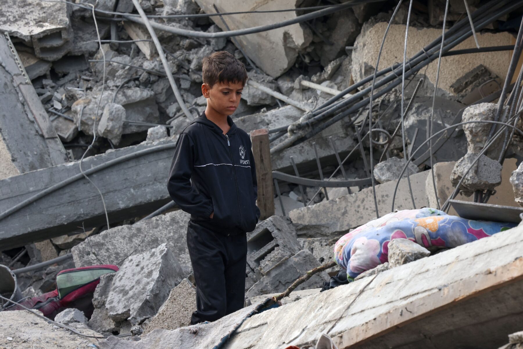 war image of Palestian boy in rubble